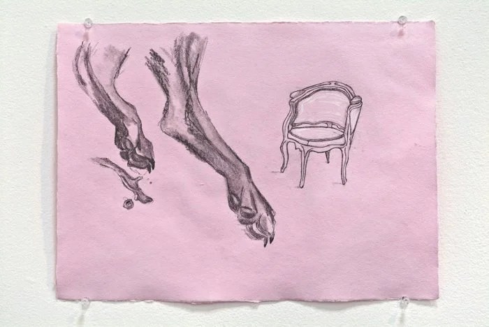 Sketch of two animal paws, possibly a dog's, and a vintage-style chair on pink paper
